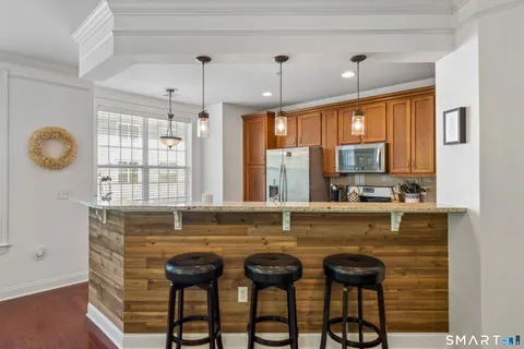 a view of a kitchen with granite countertop a table and chairs
