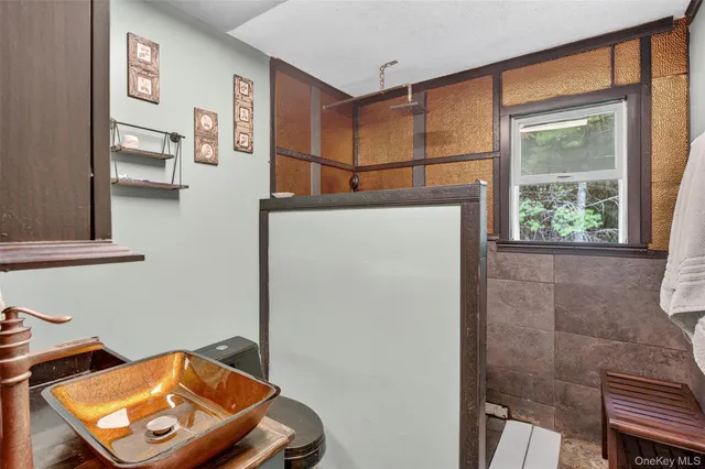a living room with furniture a bookshelf and a window