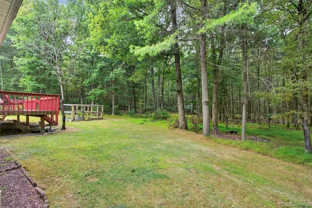 a balcony with wooden floor and outdoor space