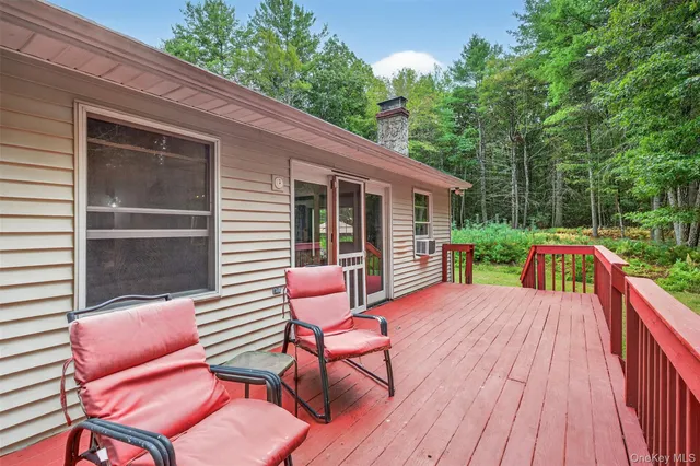 a view of backyard with outdoor seating and trees