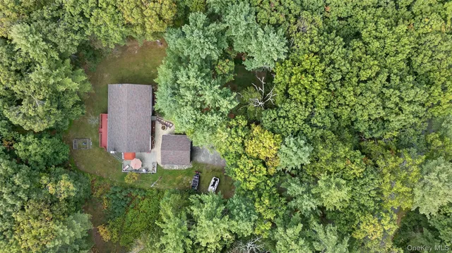 an aerial view of a house with a yard