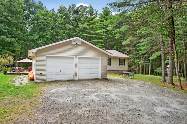 a view of a house with backyard and a tree