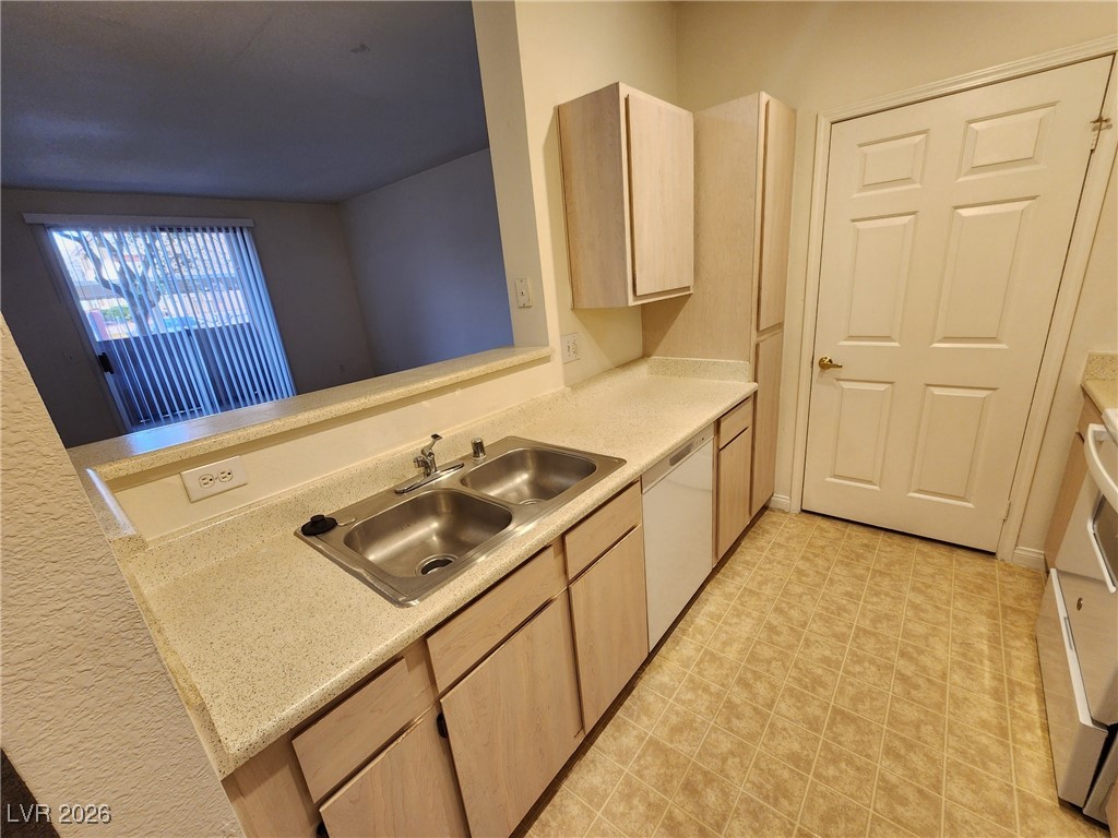 231 West Horizon Ridge Parkway, Unit 417 Henderson, NV 89012 - Photo 13 of 45 Kitchen with light countertops, light brown cabinets, stainless steel range, and dishwasher