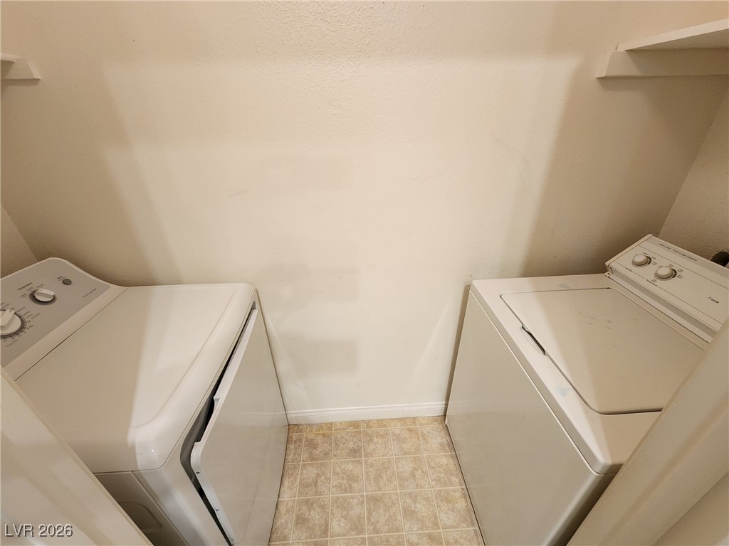 231 West Horizon Ridge Parkway, Unit 417 Henderson, NV 89012 - Photo 16 of 45 Washroom with washing machine and clothes dryer and baseboards