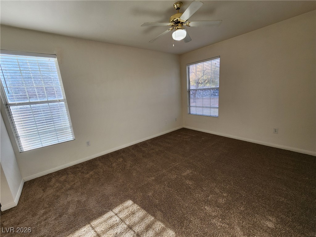 231 West Horizon Ridge Parkway, Unit 417 Henderson, NV 89012 - Photo 29 of 45 Unfurnished room with dark carpet and a ceiling fan