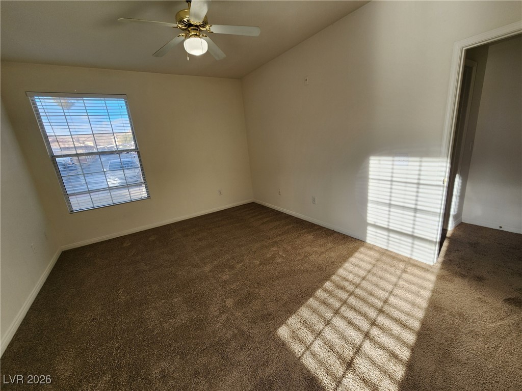 231 West Horizon Ridge Parkway, Unit 417 Henderson, NV 89012 - Photo 30 of 45 Empty room with dark carpet and ceiling fan