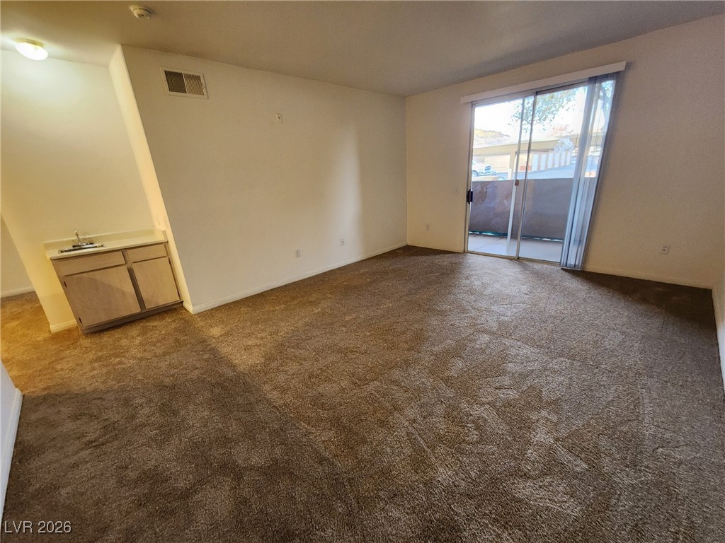 231 West Horizon Ridge Parkway, Unit 417 Henderson, NV 89012 - Photo 7 of 45 Spare room with dark colored carpet and baseboards