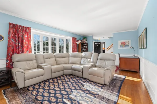 a living room with furniture ceiling fan and a rug