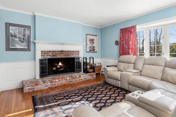 a living room with furniture a rug and a fireplace