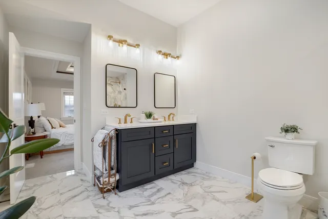 a spacious bathroom with a toilet sink and mirror