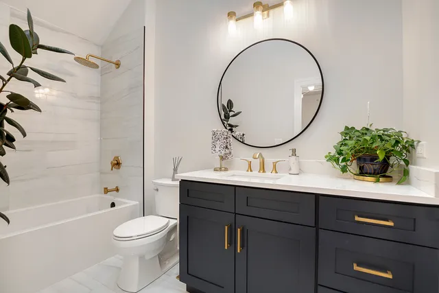 a bathroom with a toilet a sink and mirror