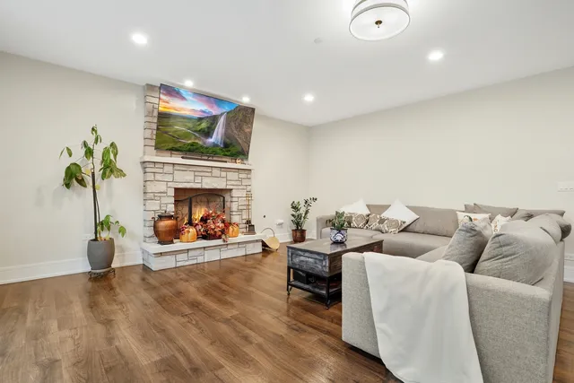 a living room with furniture a fireplace and a flat screen tv