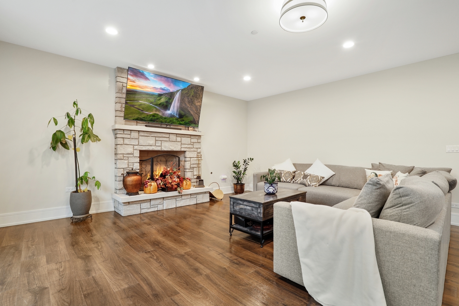8318 West 91st Street Hickory Hills, IL 60457 - Photo 18 of 29 a living room with furniture a fireplace and a flat screen tv