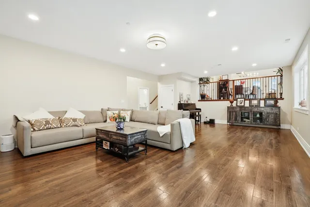 a living room with furniture and a wooden floor