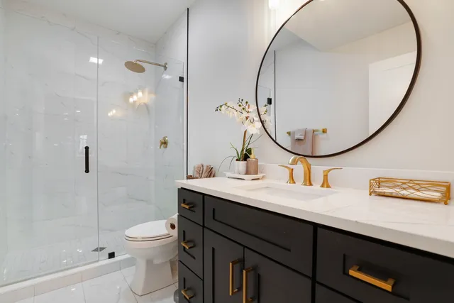 a bathroom with a sink a toilet and a mirror