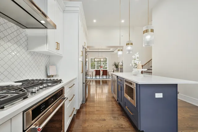 a kitchen with a stove and a chandelier