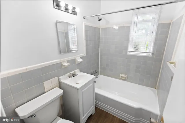 a bathroom with a sink toilet vanity and bathtub