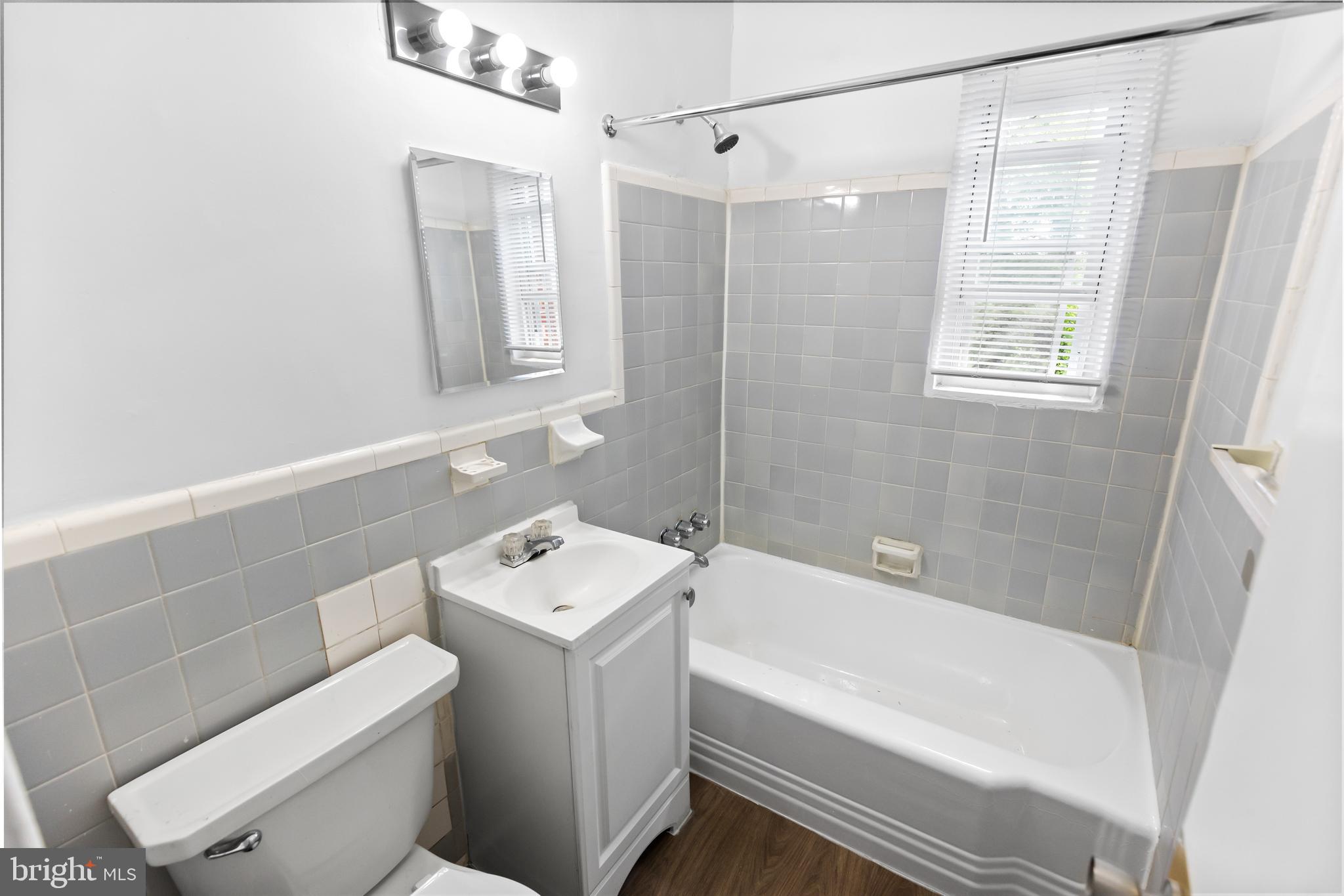 39 Mississippi Avenue Southeast, Unit 201 Washington, DC 20032 - Photo 4 of 9 a bathroom with a sink a toilet and shower