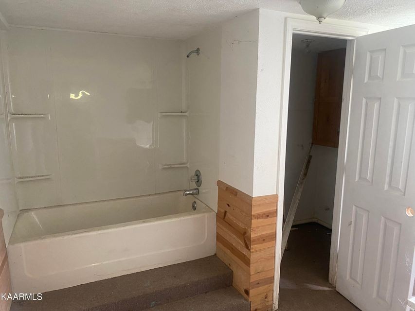 1002 Dye Road Clarkrange, TN 38553 - Photo 6 of 8 a bathroom with a bathtub and a shower