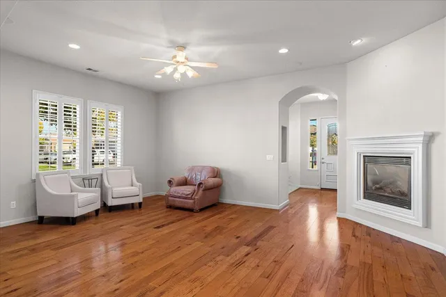 a kitchen with stainless steel appliances granite countertop a sink a stove and a wooden floor