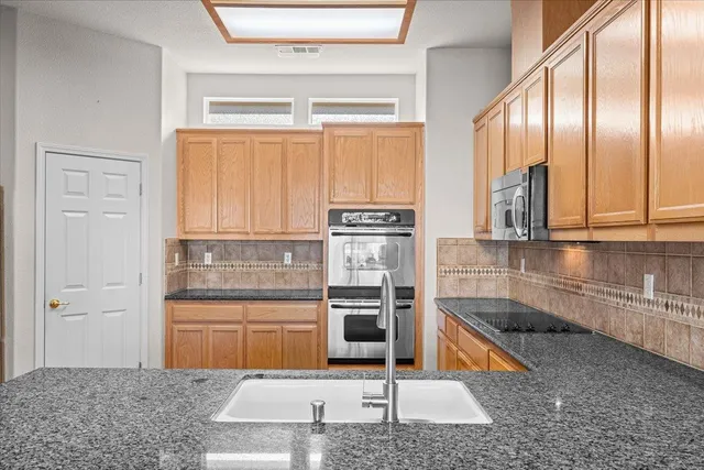 a view of a room with chandelier and wooden floor