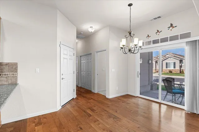 a front view of a house with a yard and potted plants