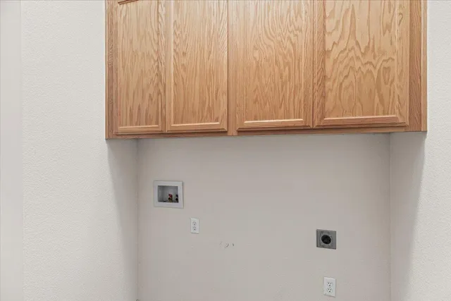 a front view of a house with a yard and potted plants