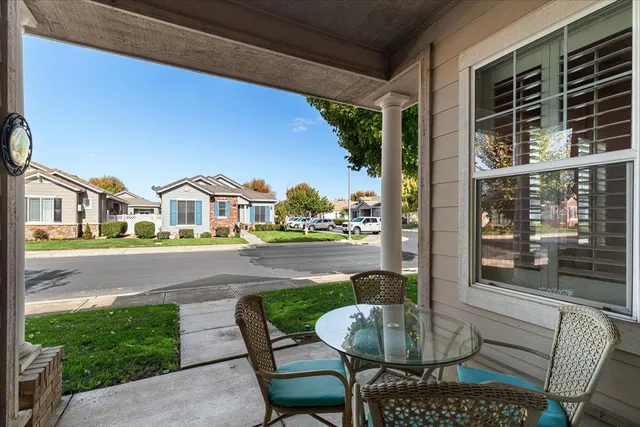 a living room with furniture pool table and a large window