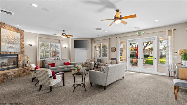 a swimming pool view with a seating space and a garden view