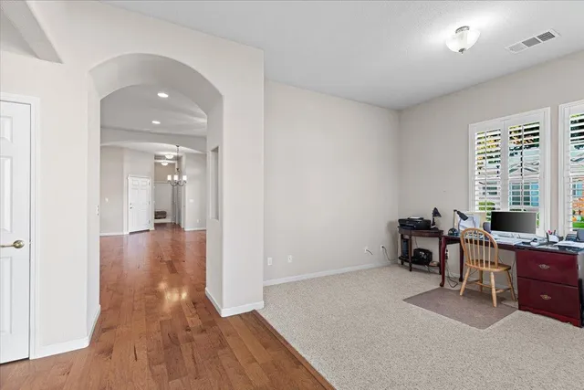 a view of a workspace with furniture and a window