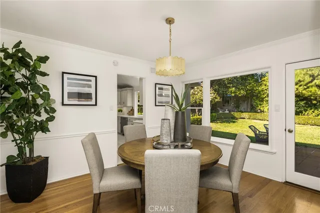 a dining room with furniture window and wooden floor