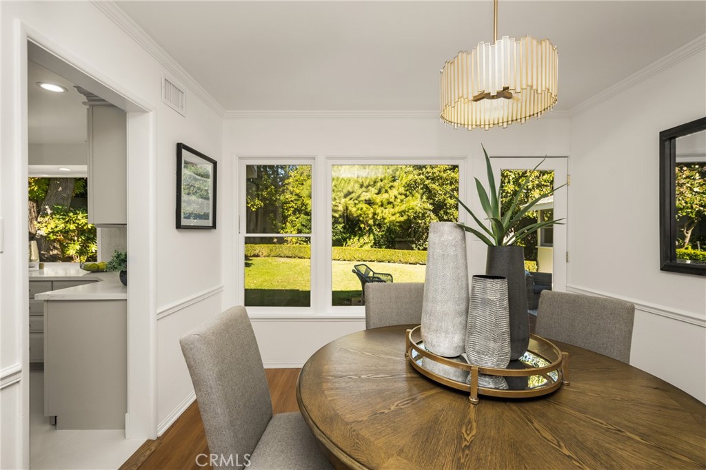1225 Wabash Street Pasadena, CA 91103 - Photo 12 of 43 a dining room with wooden floor a chandelier a glass table and chairs