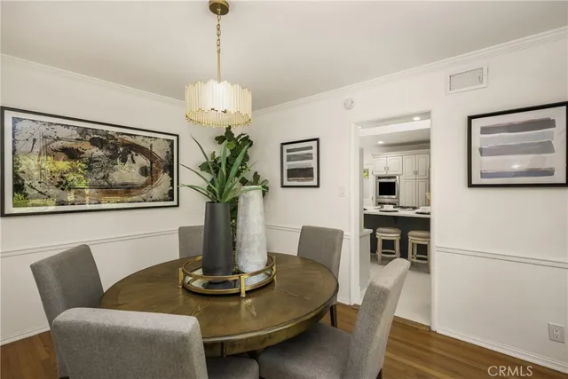 a dining room with furniture and wooden floor