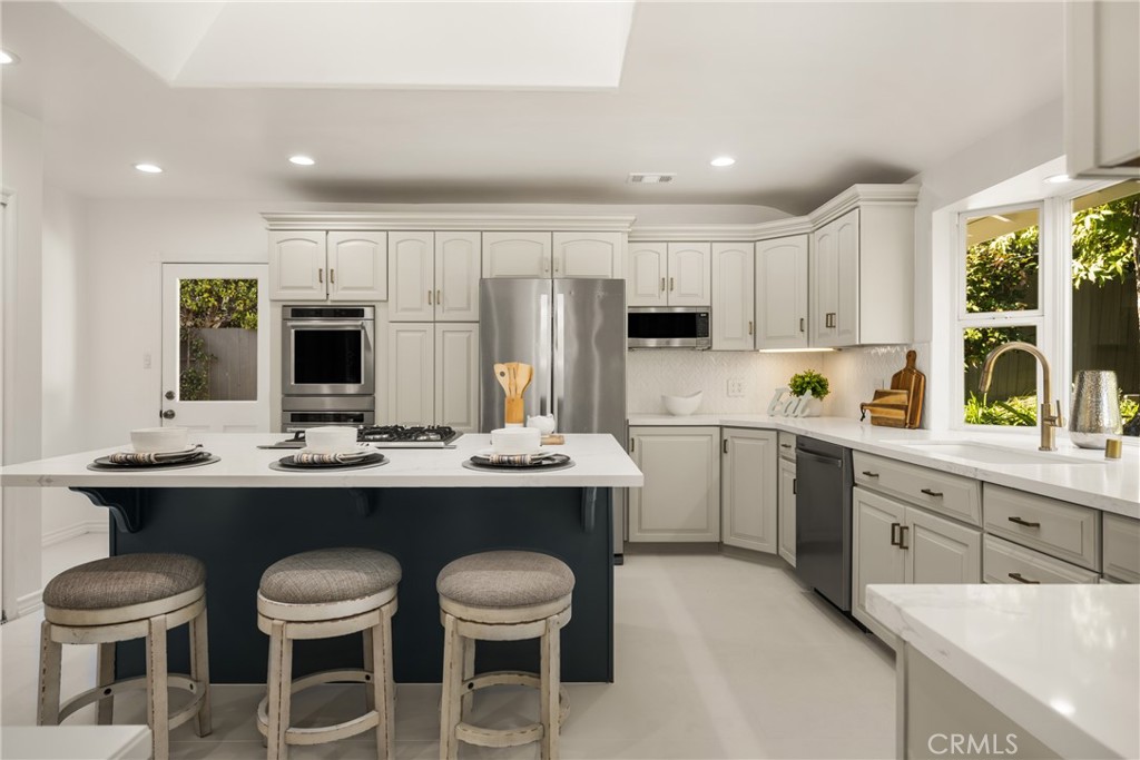 1225 Wabash Street Pasadena, CA 91103 - Photo 14 of 43 a kitchen with a sink and chairs