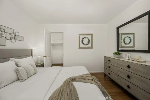 a bedroom with a bed and wall painting