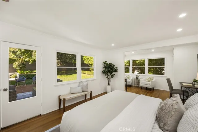 a bedroom with a bed and large window