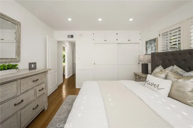 a large bedroom with a bed and a dresser