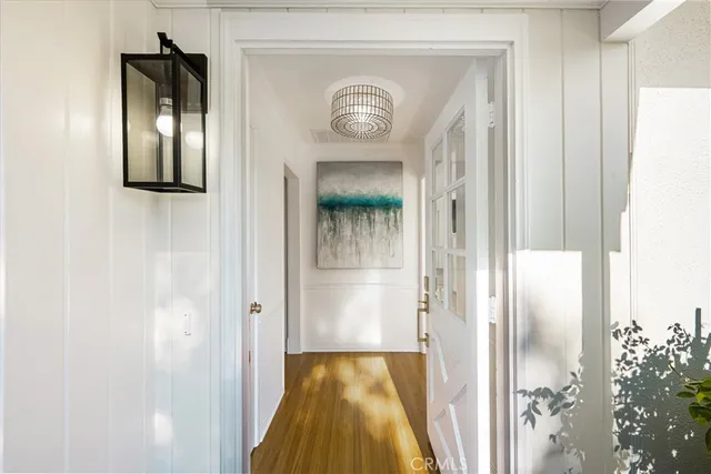 a view of a hallway with wooden floor
