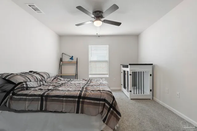a bedroom with furniture and a window