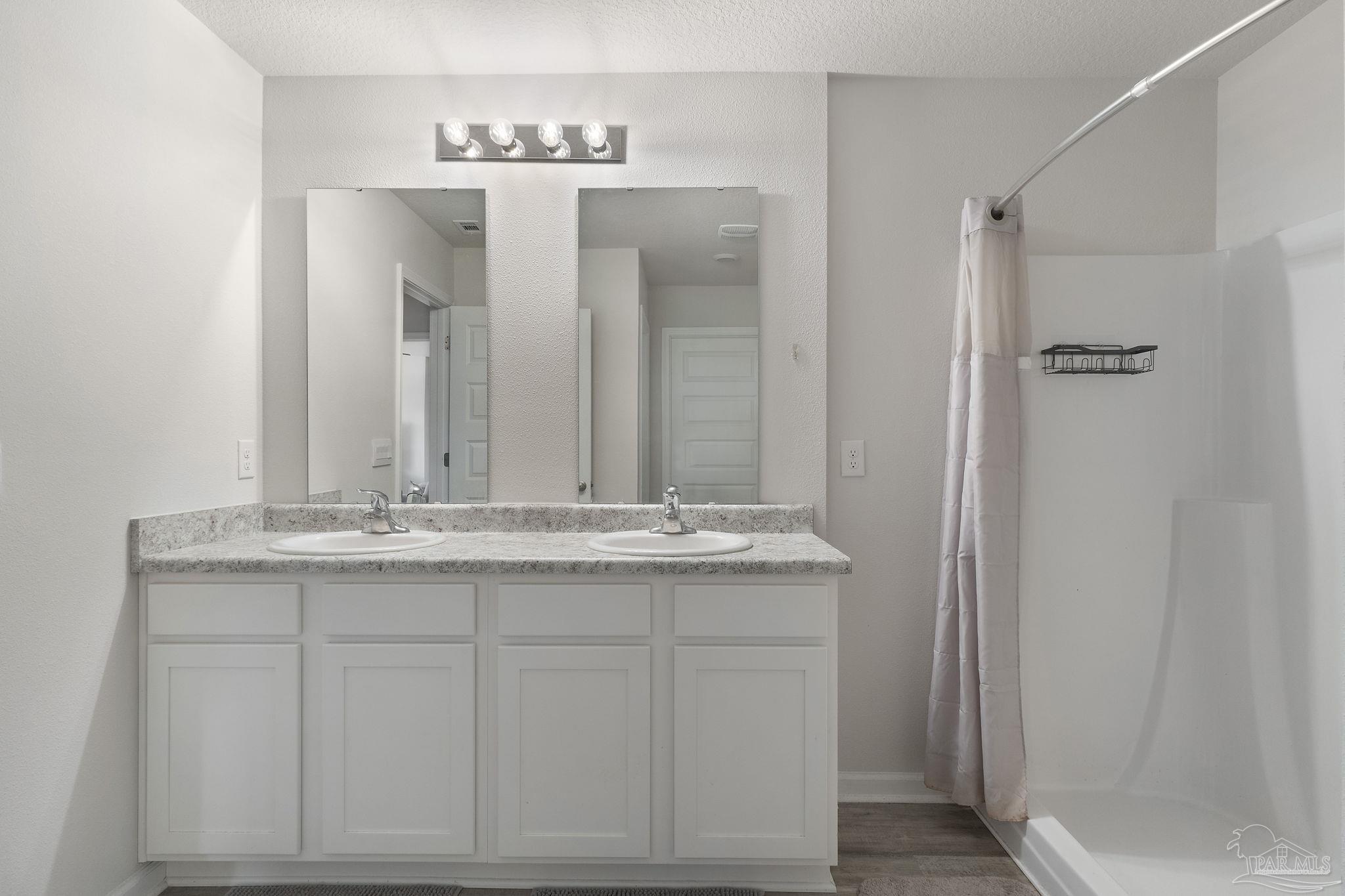 4358 Redbay Court Pace, FL 32571 - Photo 27 of 47 a bathroom with a granite countertop sink and a mirror