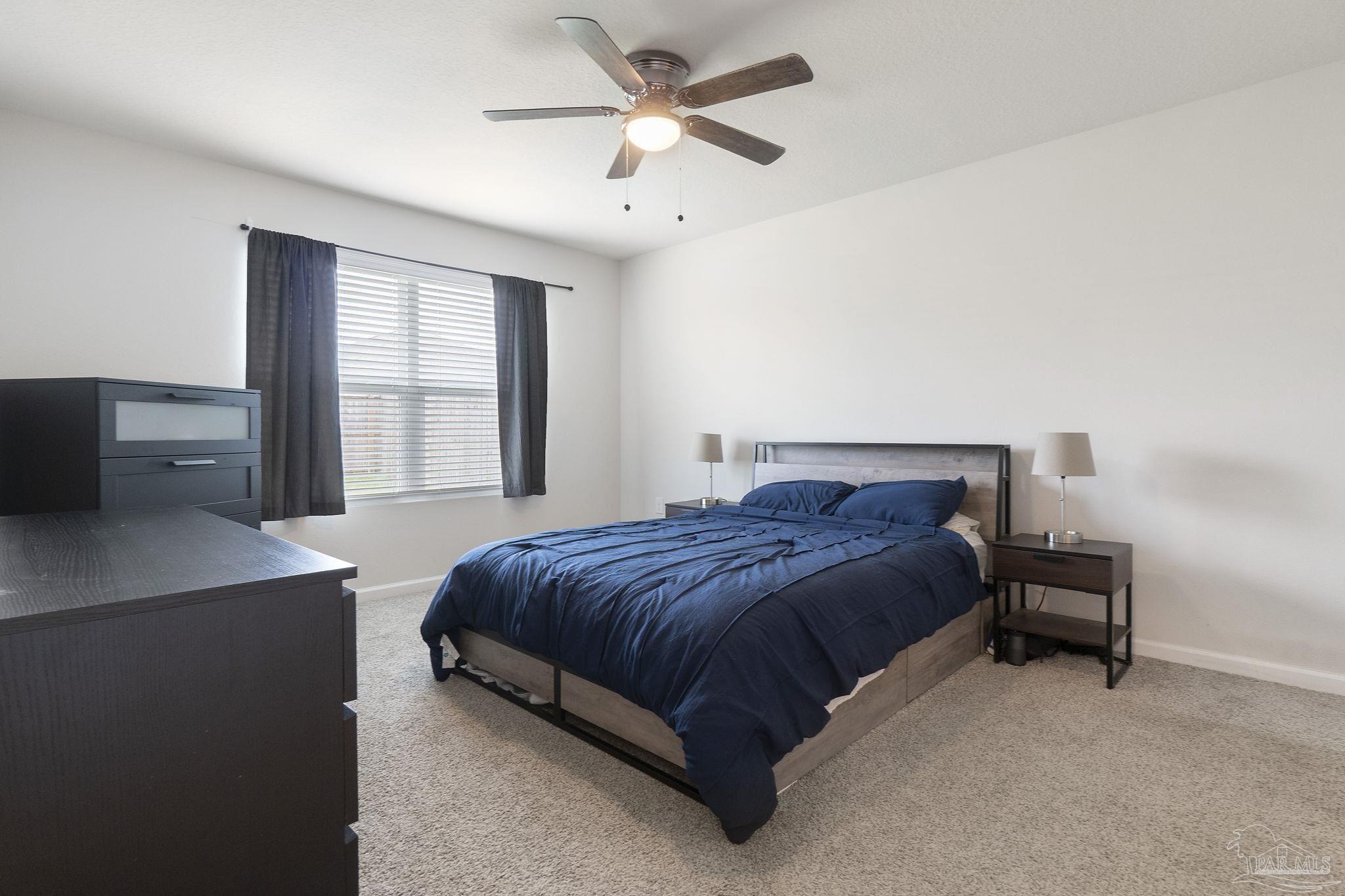 4358 Redbay Court Pace, FL 32571 - Photo 29 of 47 a bedroom with a bed and a chandelier