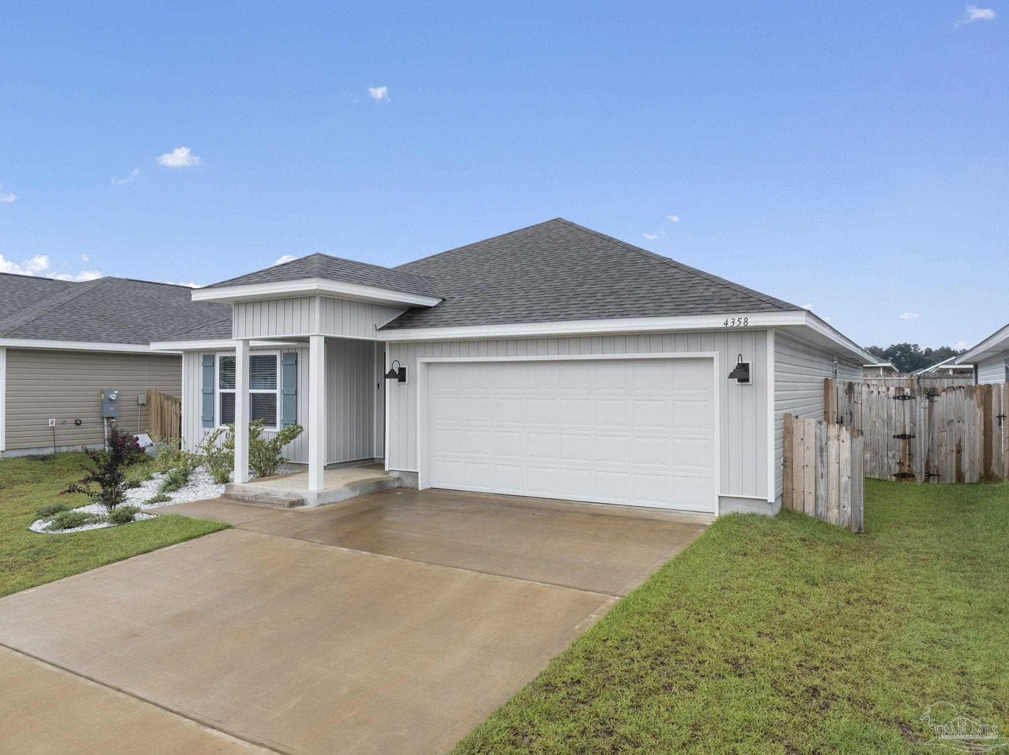 4358 Redbay Court Pace, FL 32571 - Photo 3 of 47 a front view of a house with a yard and garage