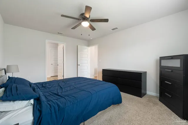 a bedroom with a bed and a dresser