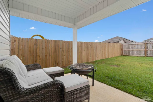 a backyard of a house with table and chairs