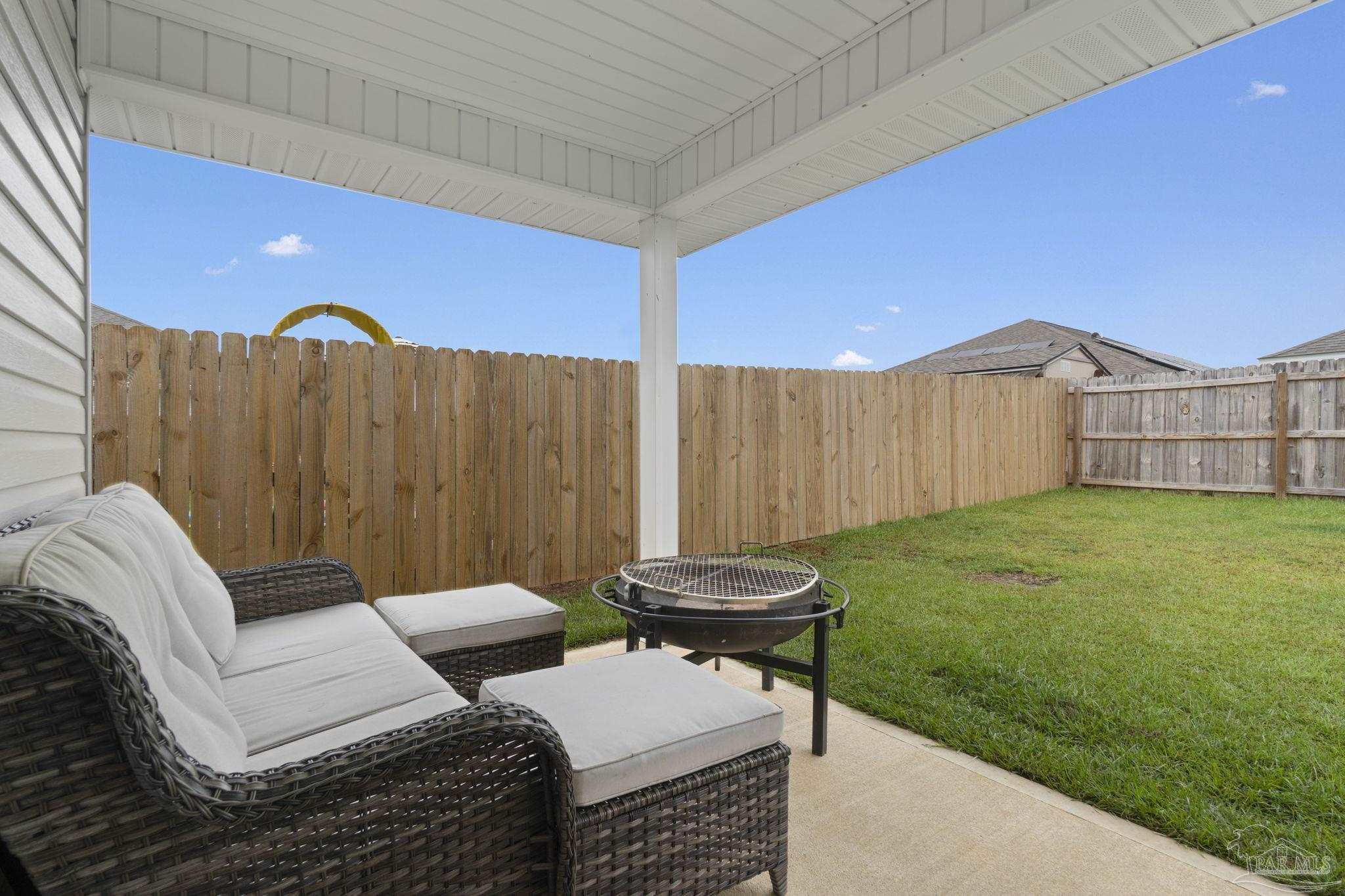 4358 Redbay Court Pace, FL 32571 - Photo 32 of 47 a backyard of a house with table and chairs
