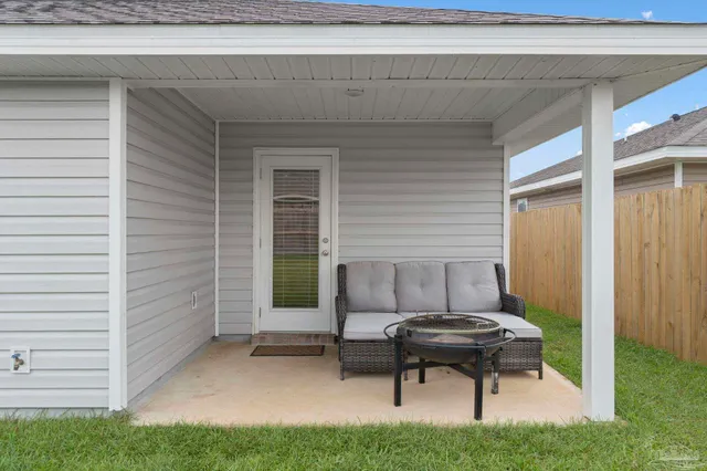 a house view with a outdoor seating