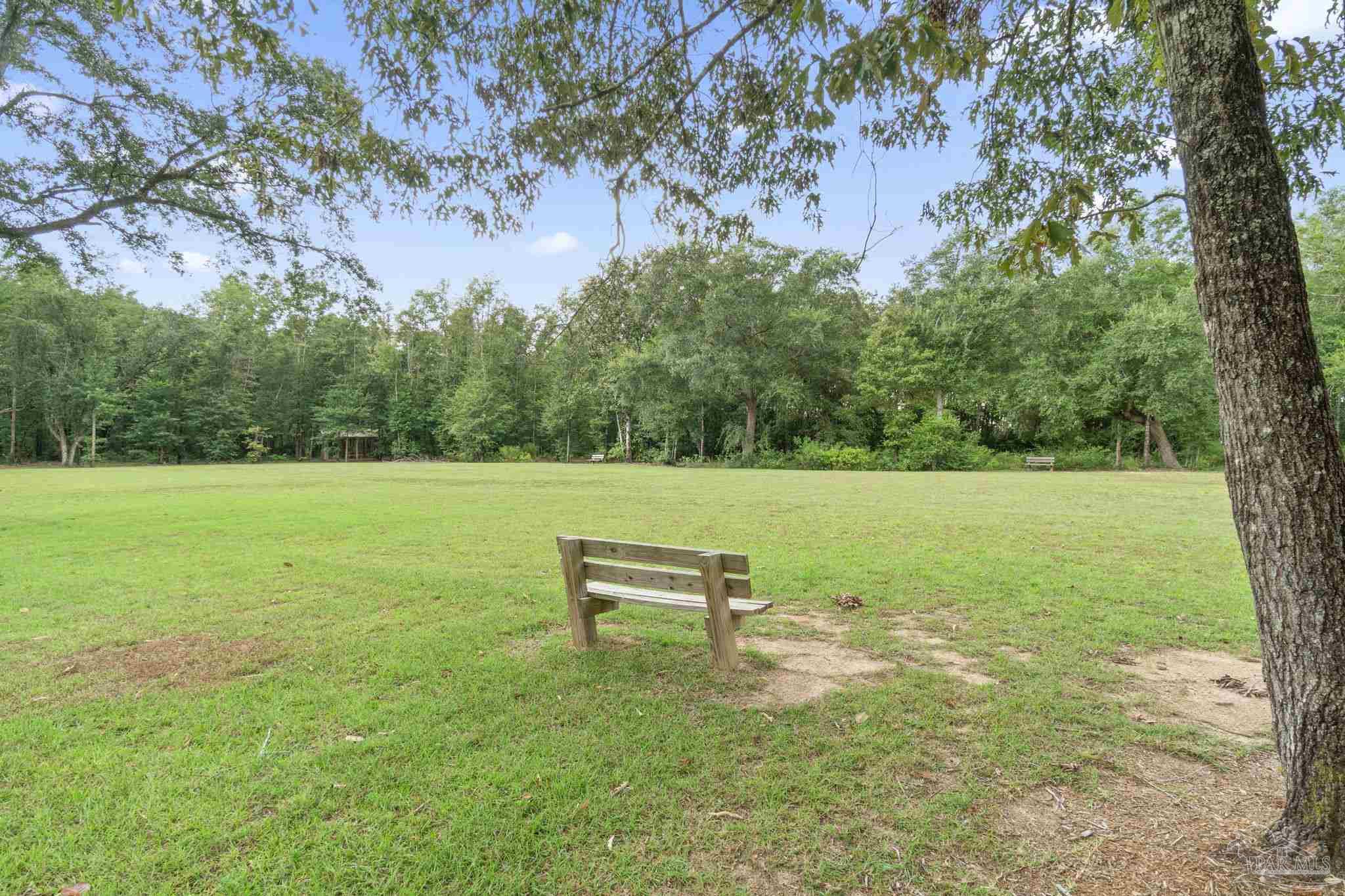 4358 Redbay Court Pace, FL 32571 - Photo 46 of 47 a view of a bench in a garden