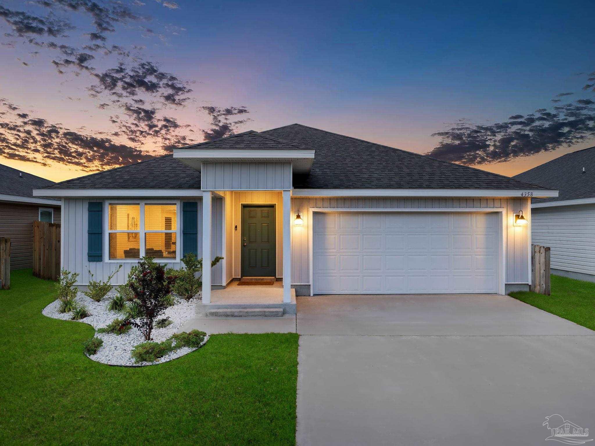 4358 Redbay Court Pace, FL 32571 - Photo 47 of 47 a front view of a house with a garden and plants