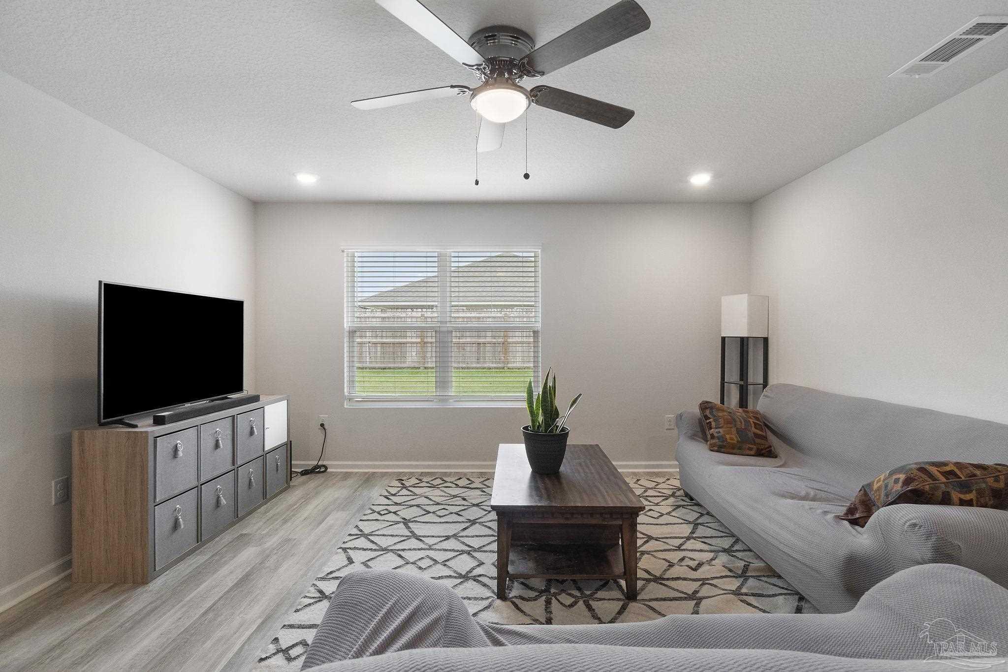 4358 Redbay Court Pace, FL 32571 - Photo 8 of 47 a living room with furniture and a flat screen tv