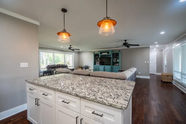 a view of living room with granite countertop furniture and wooden floor